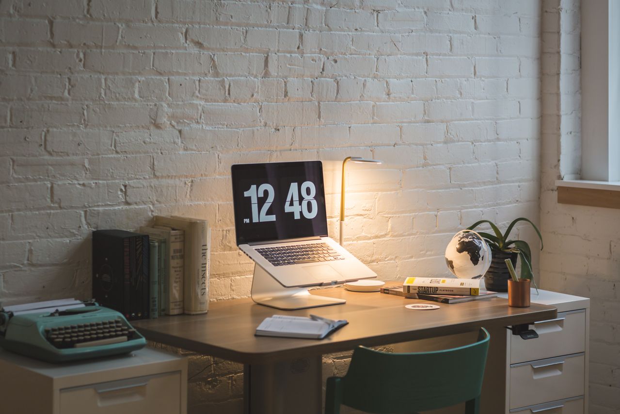 Minimal office desk setup with chair, desktop computer, and modern workspace furniture in a clean office environment
